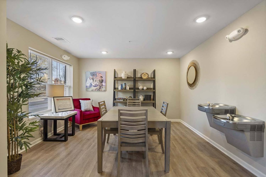 a dining room with a table and chairs and a sink