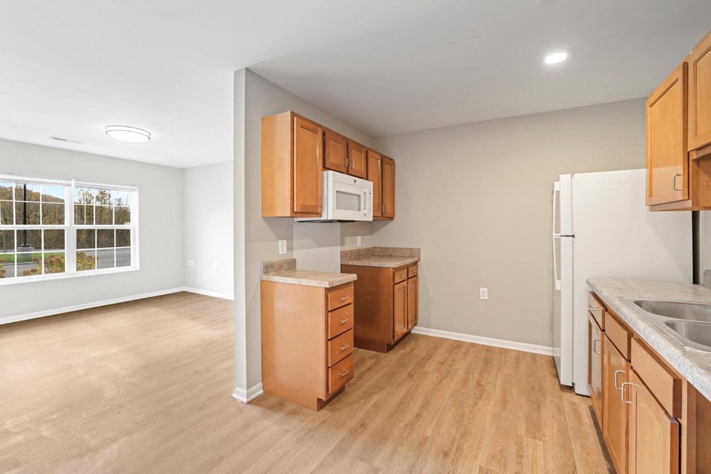 a kitchen with wooden cabinets and a white refrigerator