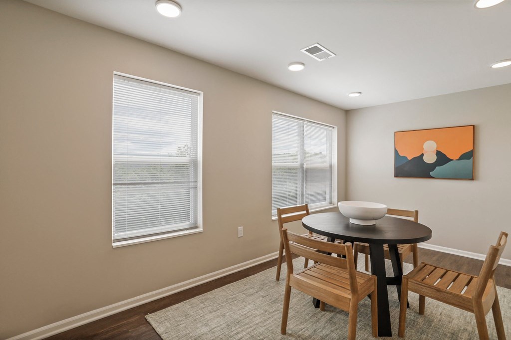 a dining room with a table and chairs