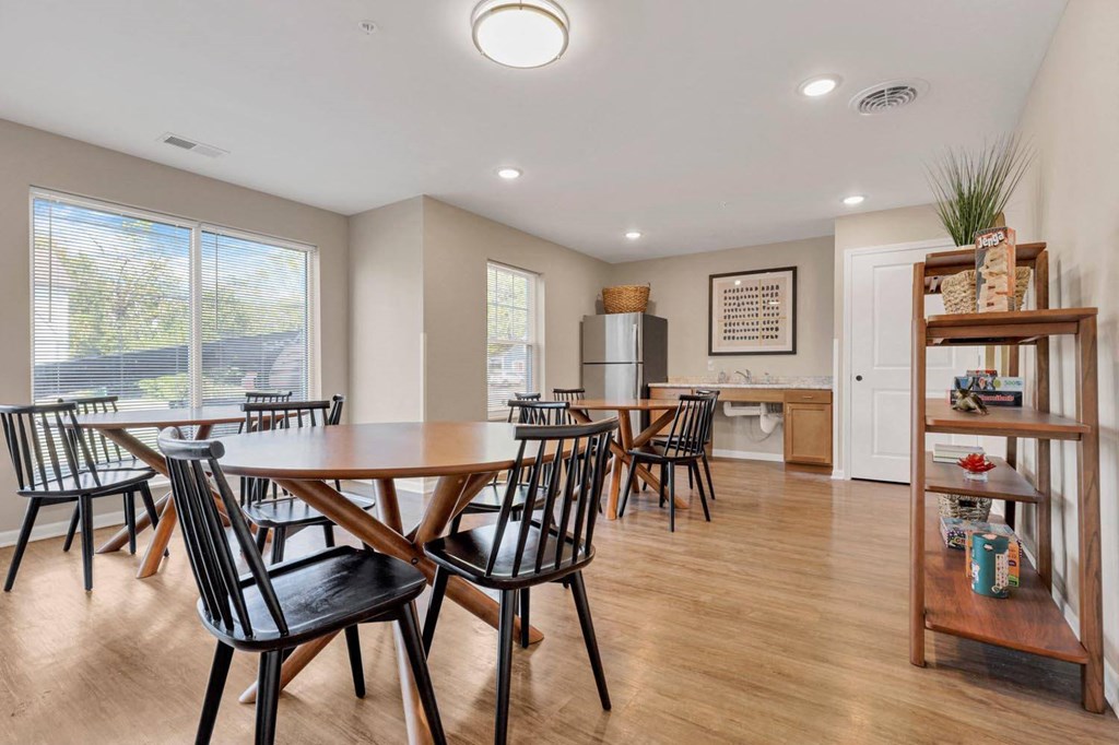 a dining room with a table and chairs and a kitchen