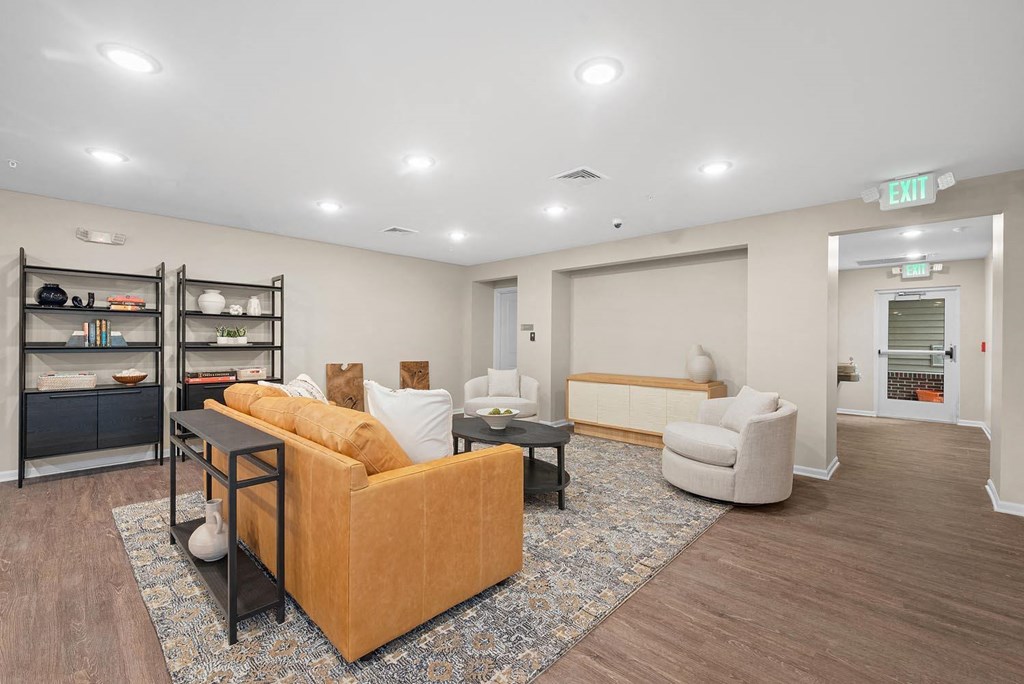 A living room with a sofa, armchair, and a coffee table.