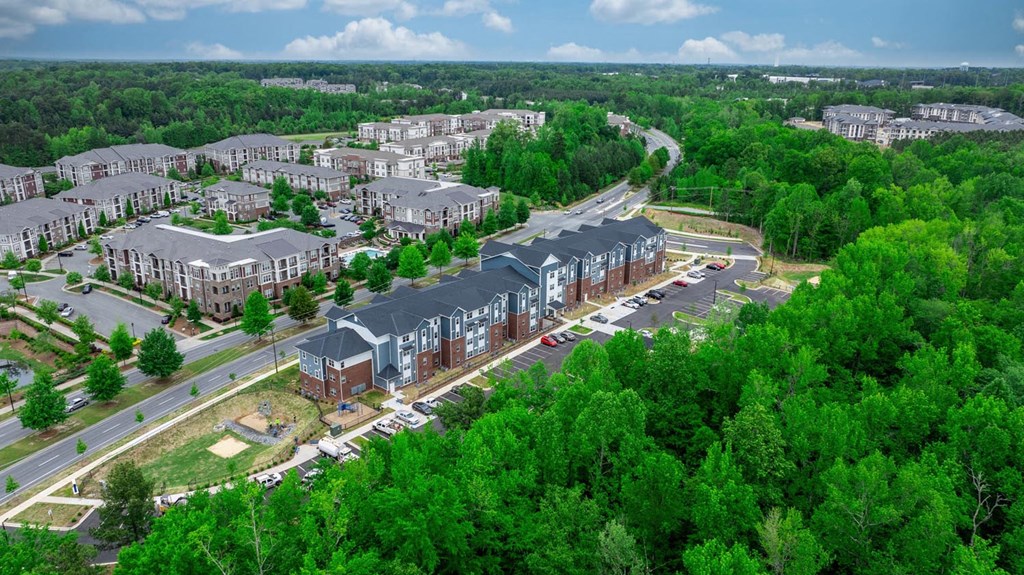 an aerial view of a city with houses and trees