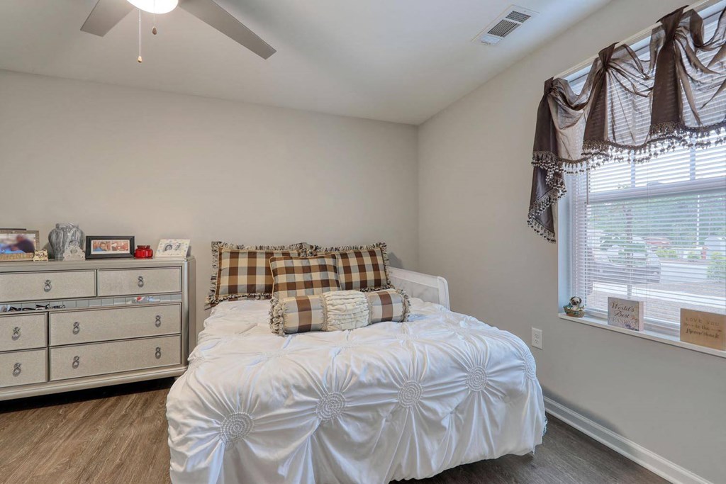 a bedroom with a bed and a dresser