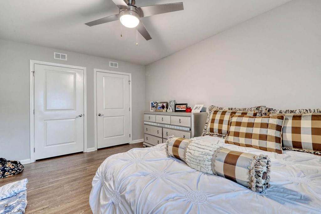 a bedroom with a bed and a ceiling fan