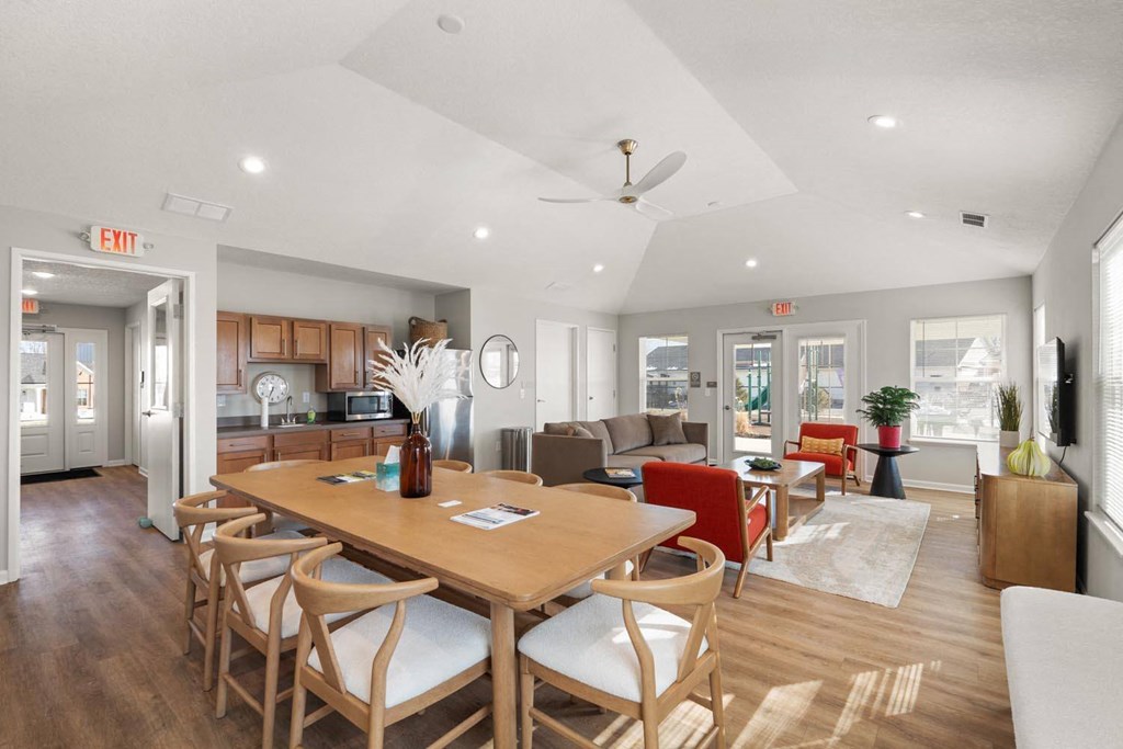 A dining room with a wooden table and chairs.