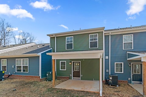 A row of houses with a clear blue sky above them.