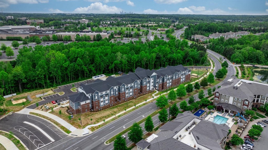 an aerial view of an apartment building next to a road