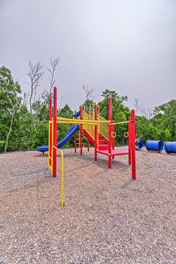 a playground with a red yellow and blue slide