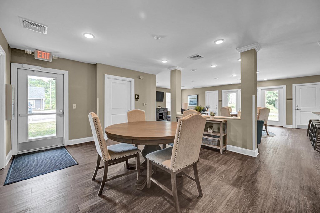 a dining room with a table and chairs