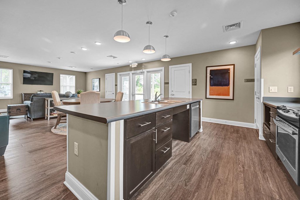 a kitchen with a center island next to a living room