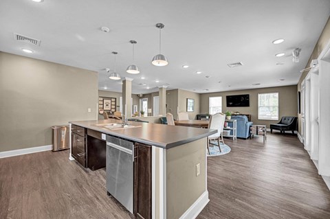 a large kitchen and living room with a counter top