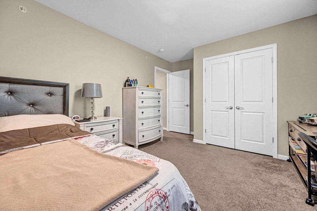 a bedroom with a bed and two closets