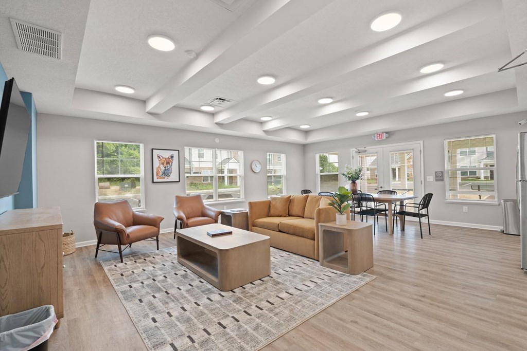 A spacious living room with a sofa, chairs, and a coffee table.
