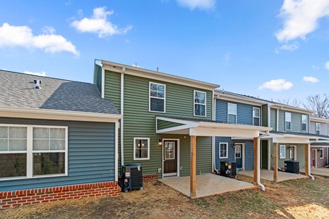 A row of houses with a blue sky in the background.