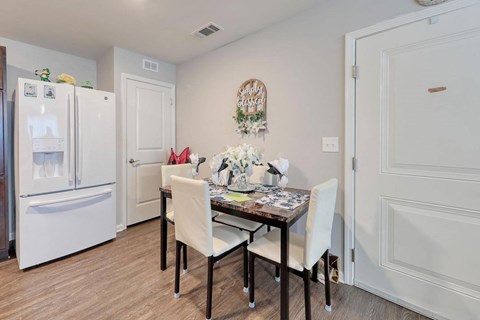 a dining room with a table and chairs