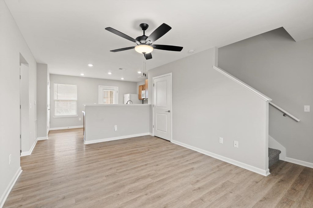 A room with a ceiling fan and lighting fixtures.