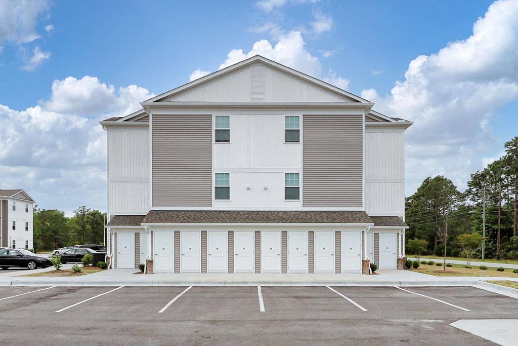 a large white building with a parking lot in front of it