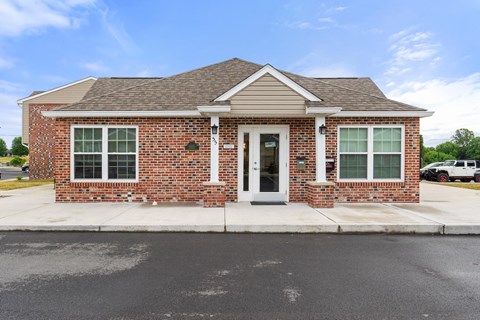 the front of a brick house with a white door