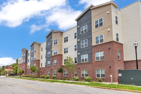 Apartment building with a mix of brick and siding exterior.