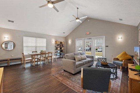 a living room with a couch and a table and a ceiling fan