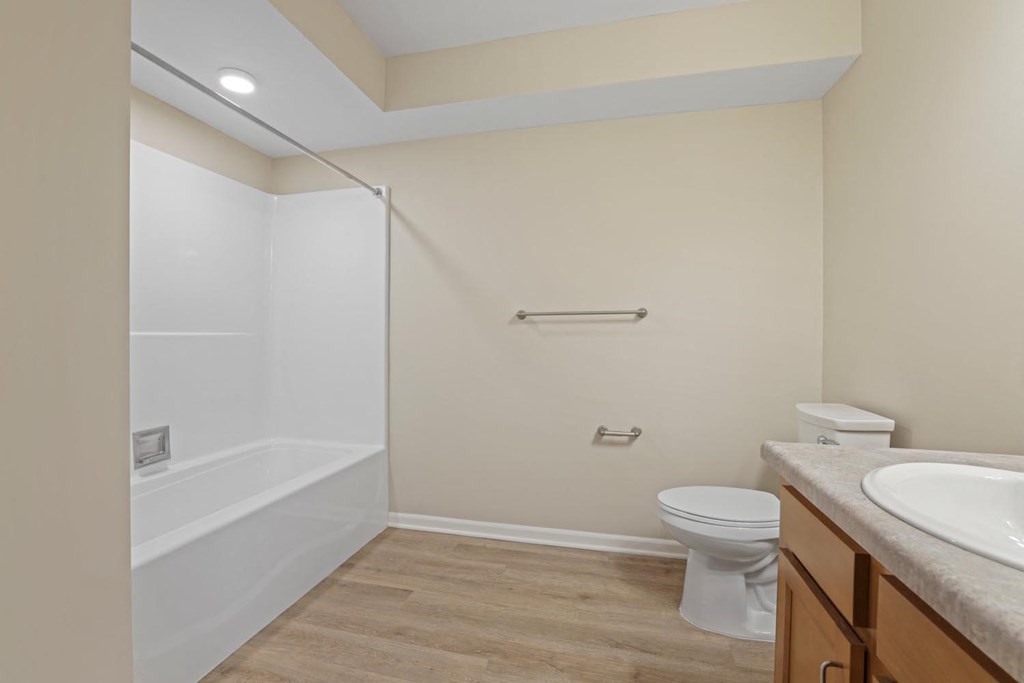 a bathroom with a toilet and a shower and a sink