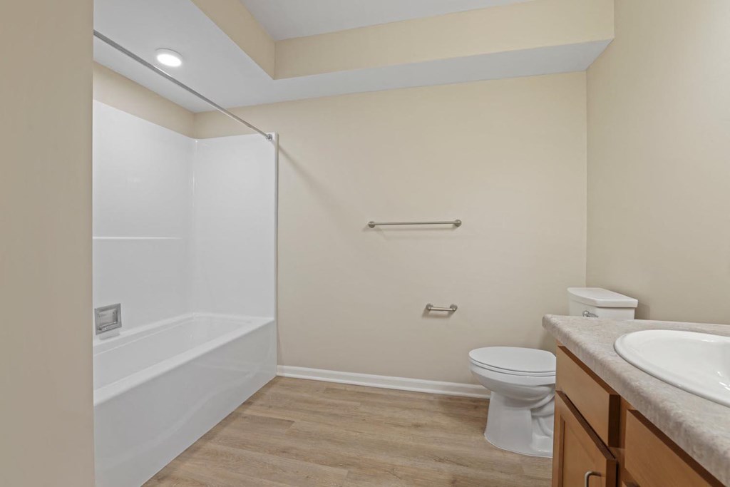 a bathroom with a toilet and a shower and a sink