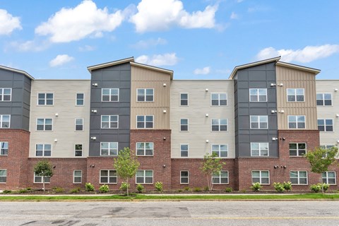 A row of apartment buildings with a clear blue sky above.