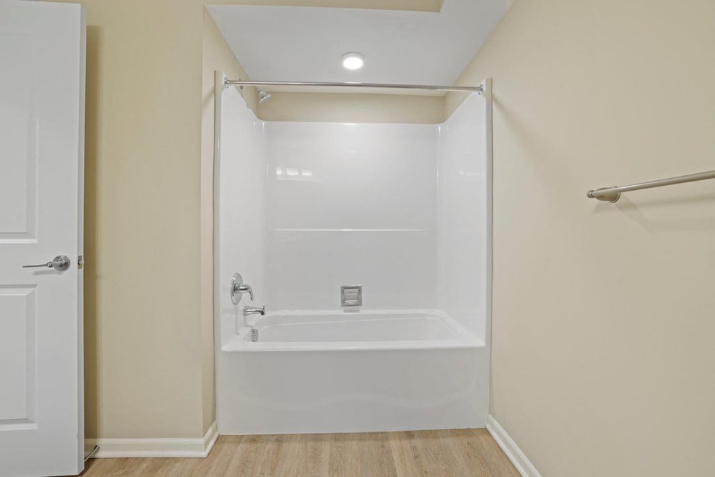 a white bathroom with a shower and a tub