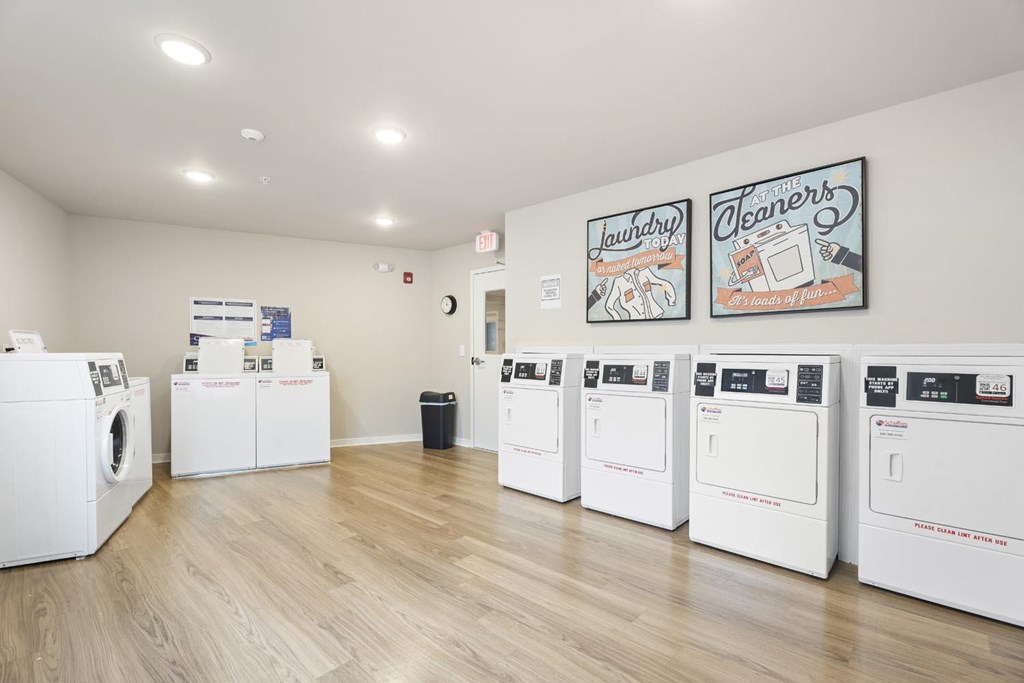 A row of washing machines are lined up in a room.