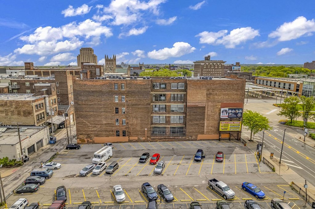 a large brick building with a parking lot in front of it