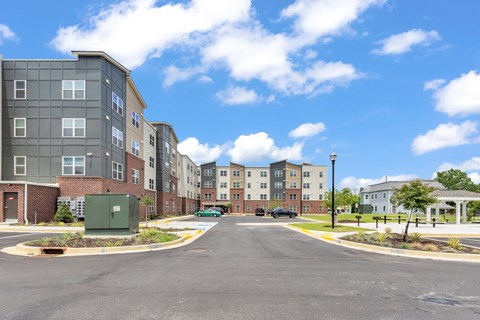 A street view of a residential area with apartment buildings on both sides.
