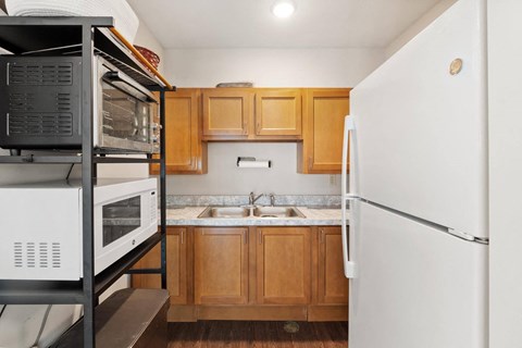 a kitchen with wooden cabinets and a white refrigerator