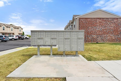 the mailbox is on the sidewalk in front of a building