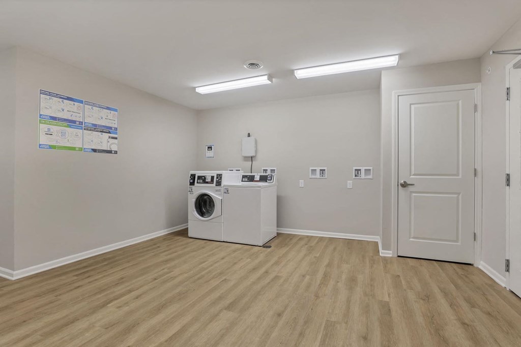 a white room with a washing machine and a white door