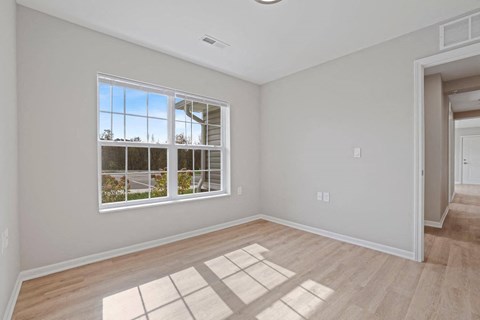 an empty living room with a large window