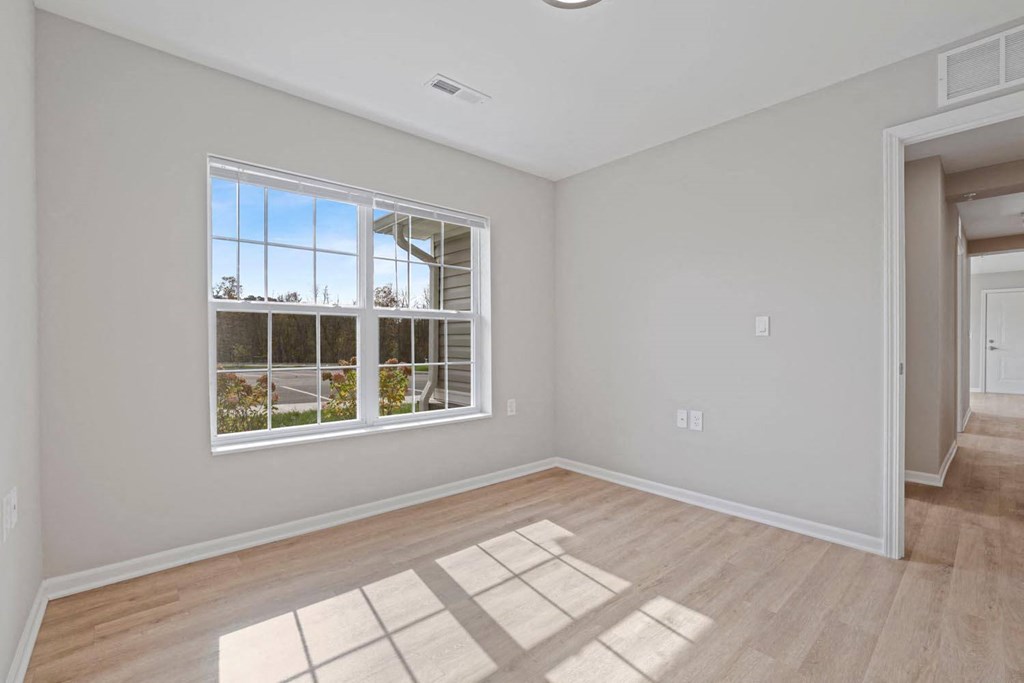 an empty living room with a large window