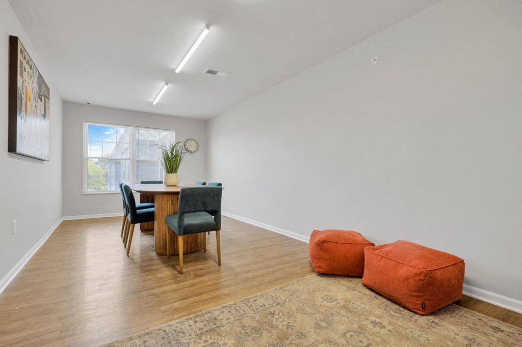 a living room with an orange couch and a dining room table