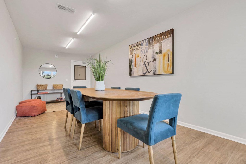 a dining room with a wooden table and blue chairs