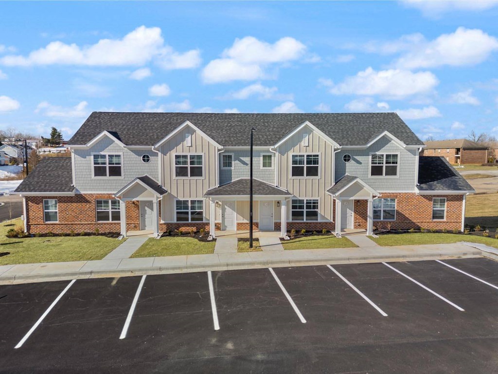 A large building with a parking lot in front of it.