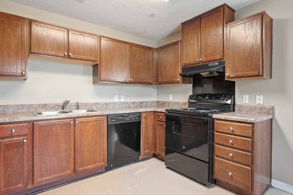 a kitchen with black appliances and wooden cabinets
