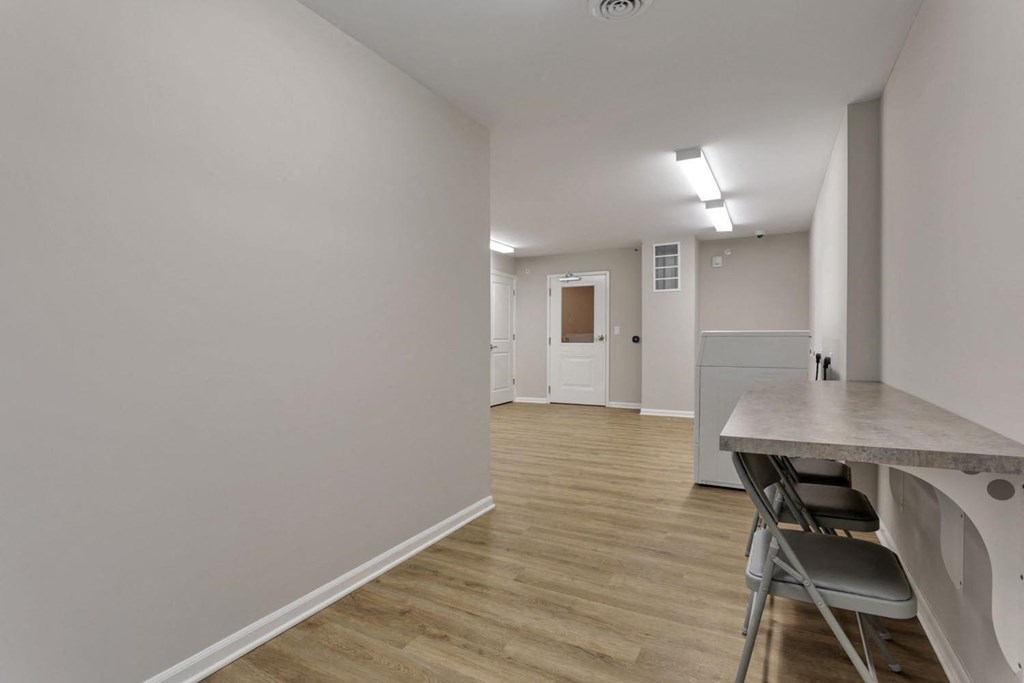 a dining room and kitchen with a table and chairs