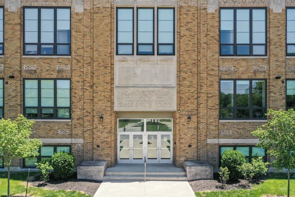 the front of a brick building with white doors