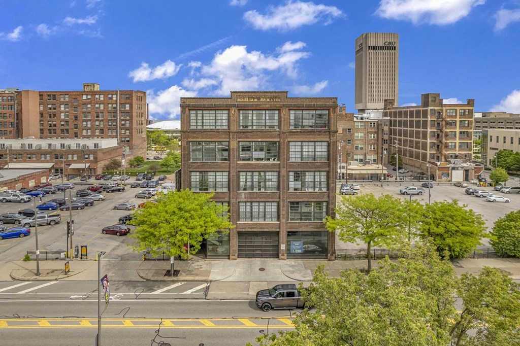 a brick building with a garage in the middle of a city