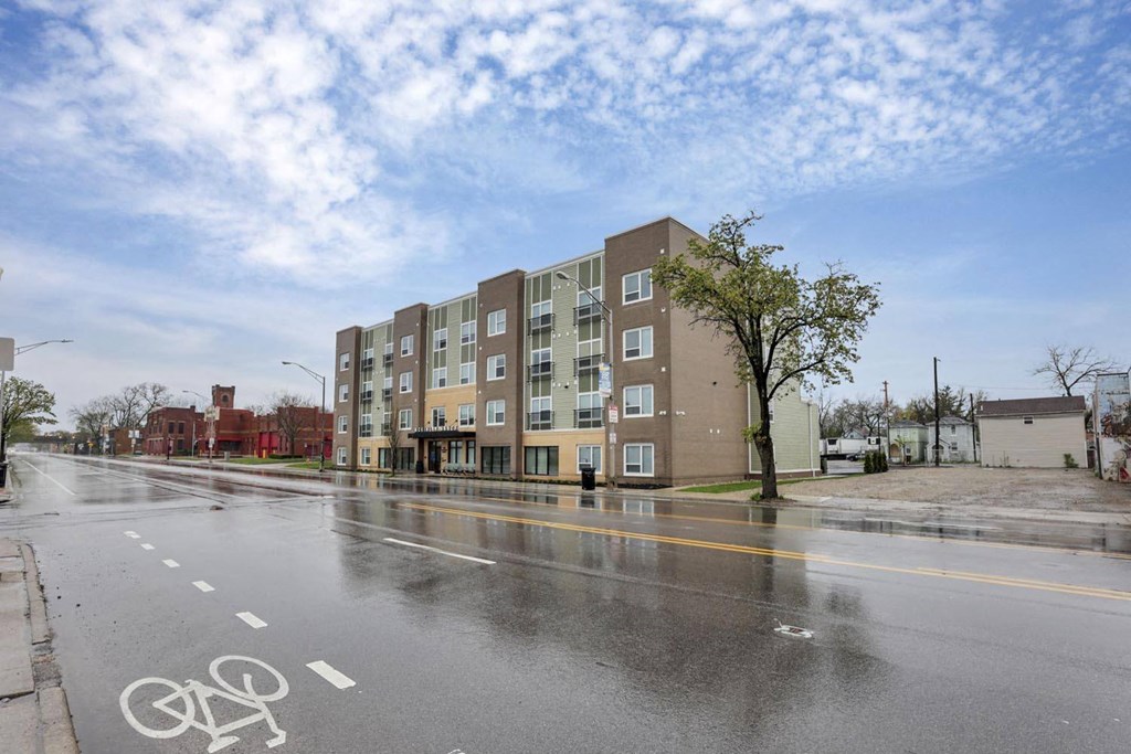 an empty street in front of an apartment building
