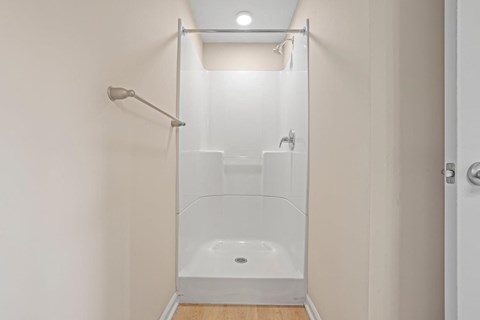 a white bathroom with a shower and a shower curtain