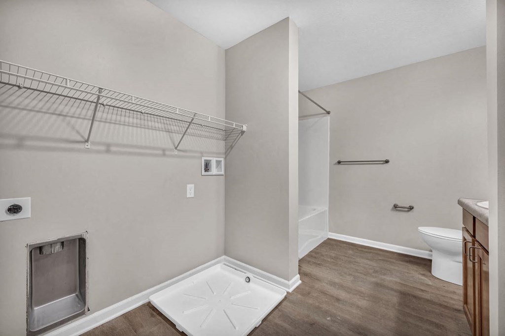 a bathroom with a shower and a toilet and a closet