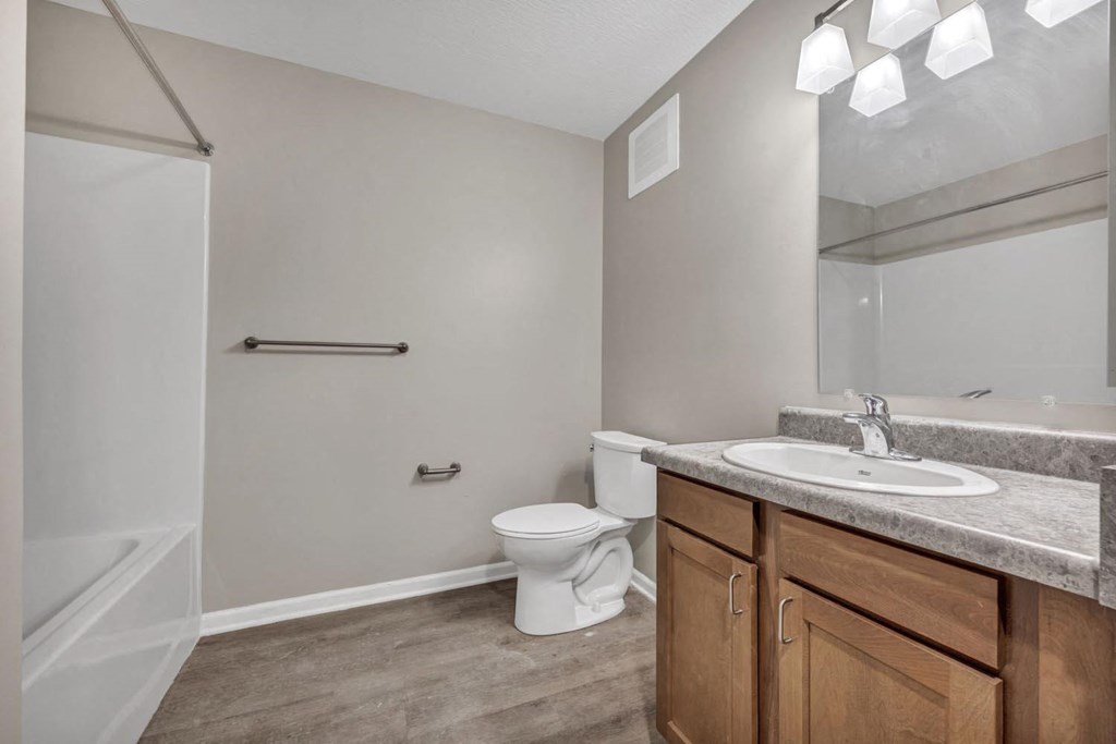 a bathroom with a sink toilet and a mirror