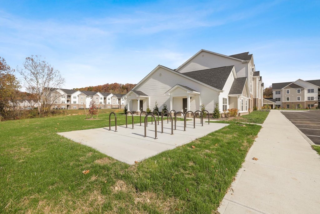 a house with a sidewalk and bike racks in front of it