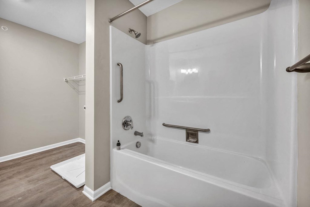 a white bathroom with a shower and a tub