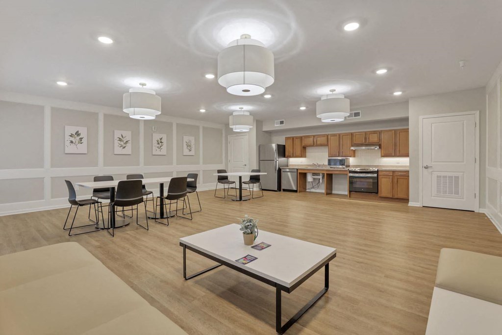 an empty living room with a table and chairs